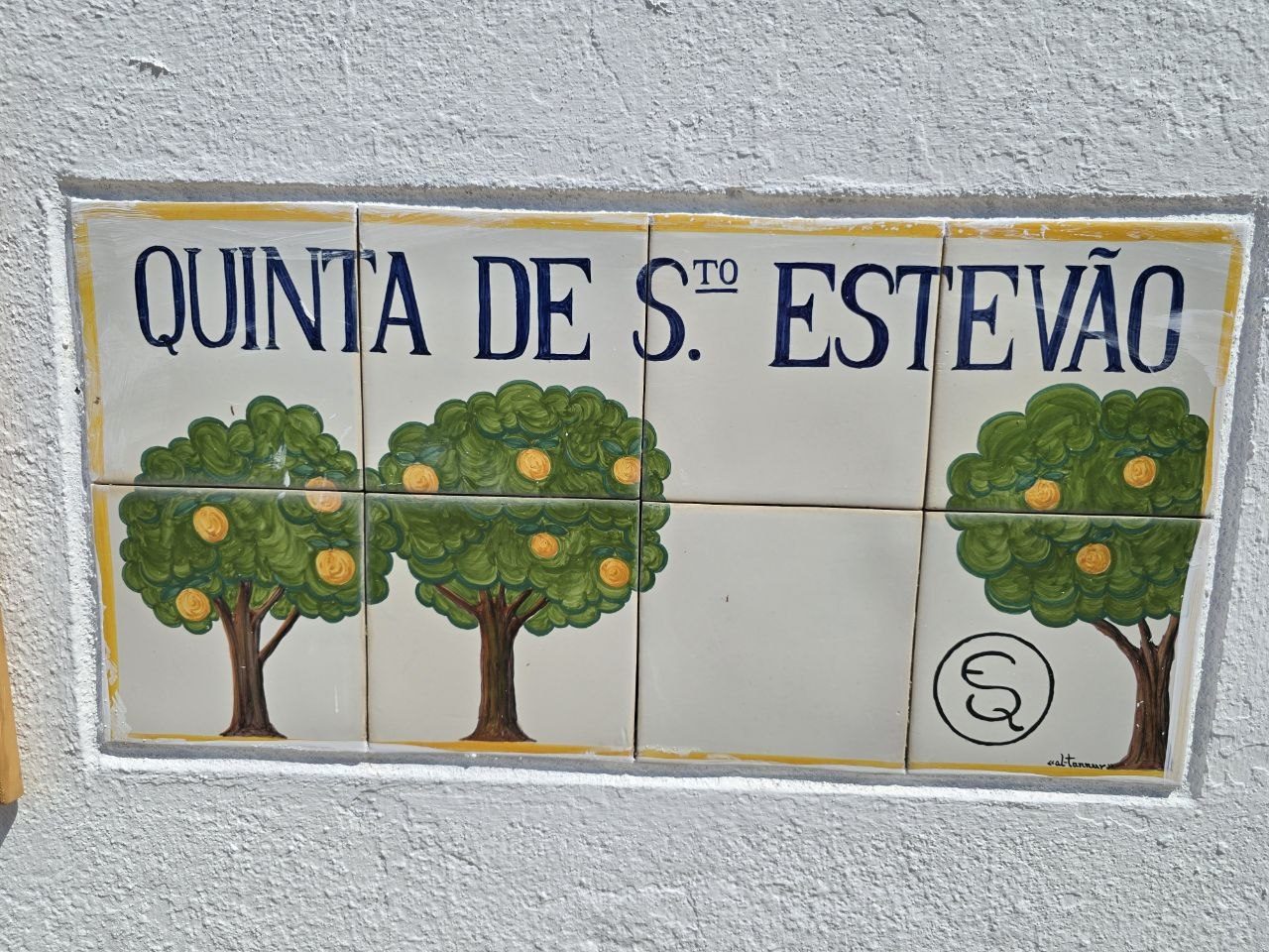 Ceramic tile sign reading Quinta de Santo Estevão with painted orange trees