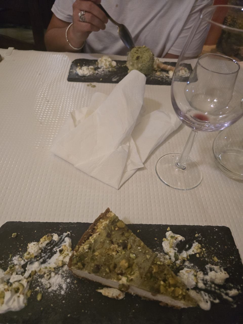 Pistachio desserts on black slate plates at La Vera dinner