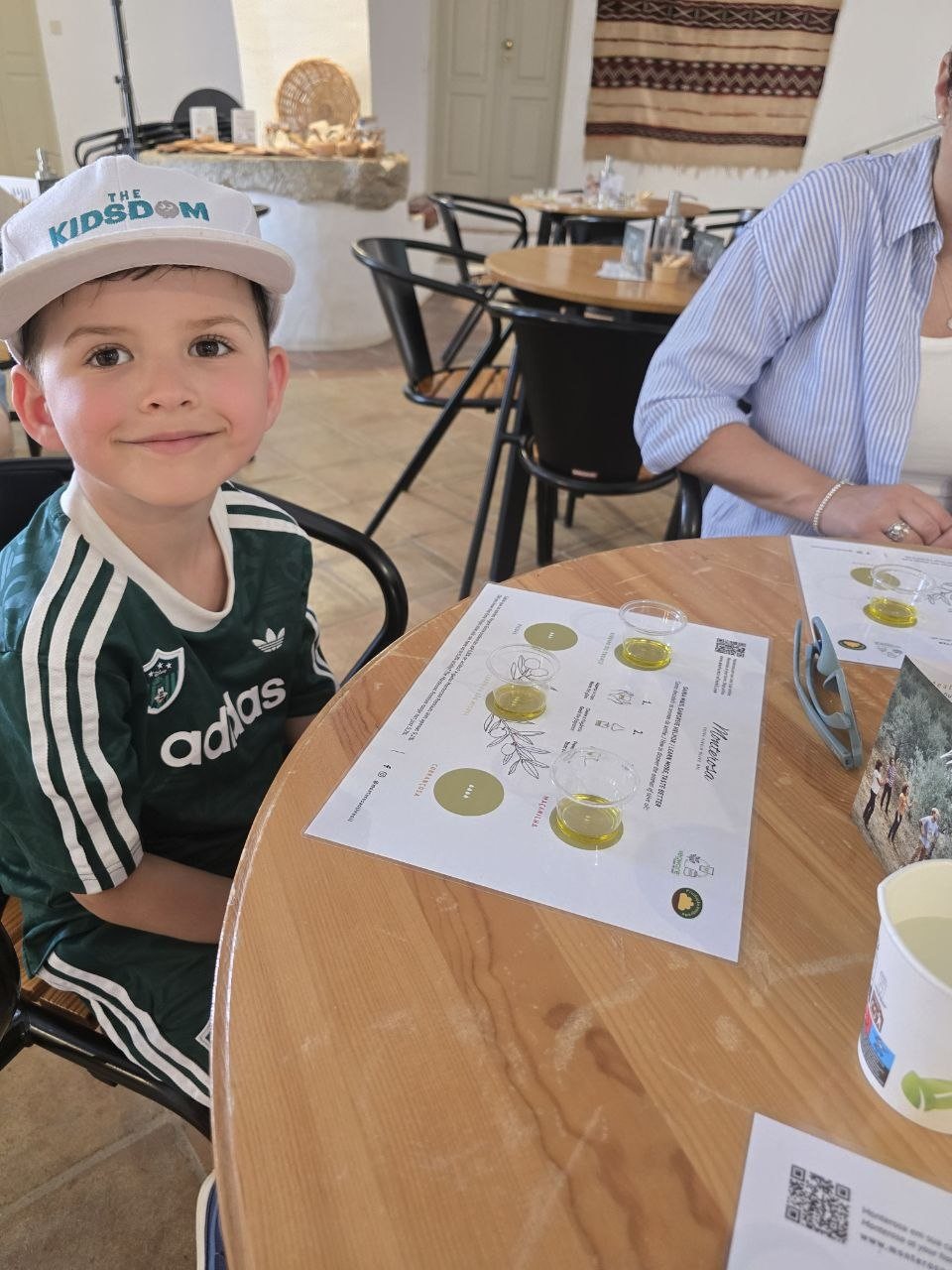 Noah smiling beside an olive oil tasting mat at Monterosa