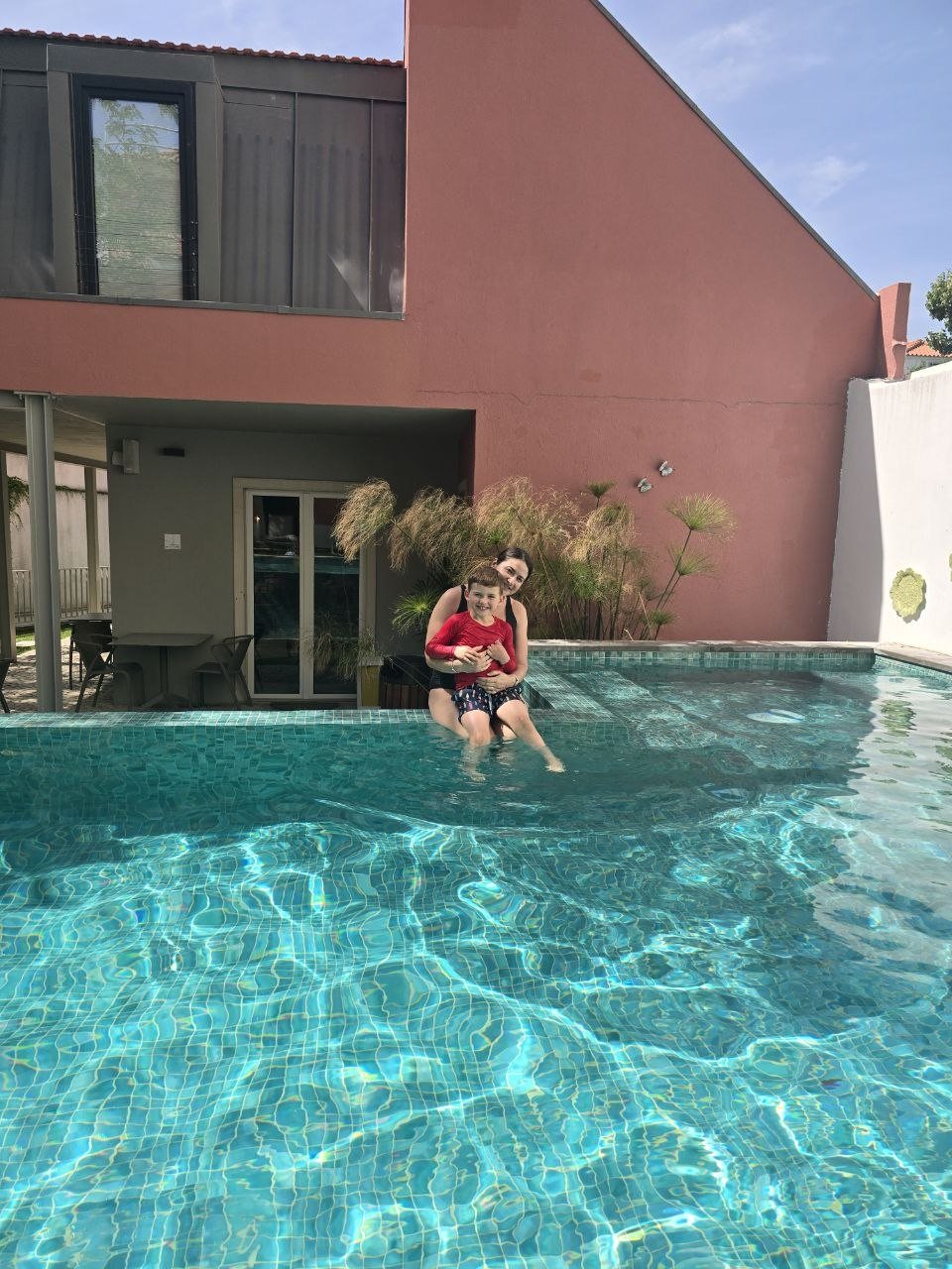 Catherine holding Noah in the Jardim da Lapa hotel pool