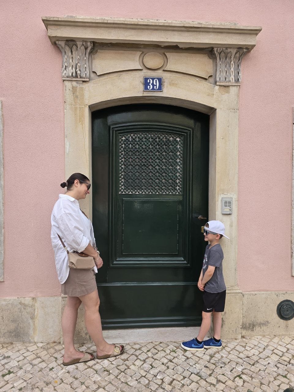 Family photo in front of a numbered Lapa doorway before heading to Belém