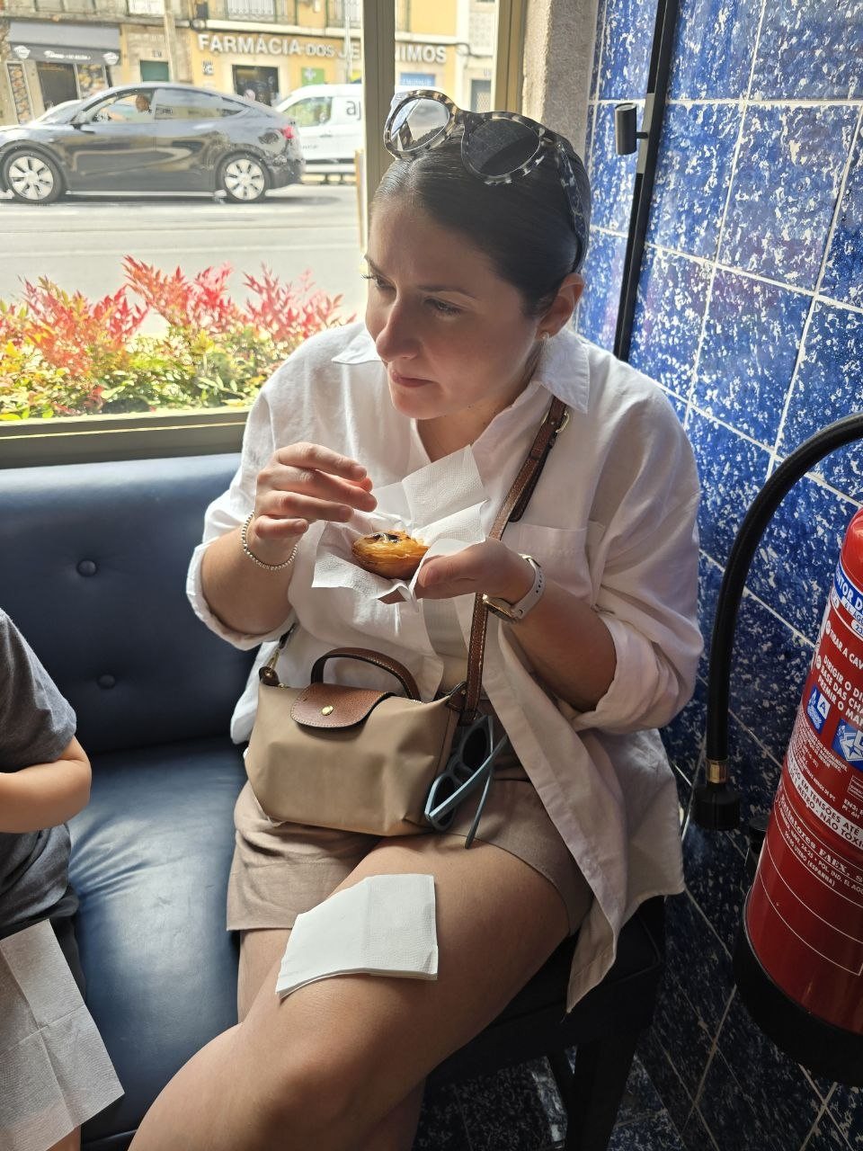 Child tasting a pastel de nata at Pastéis de Belém