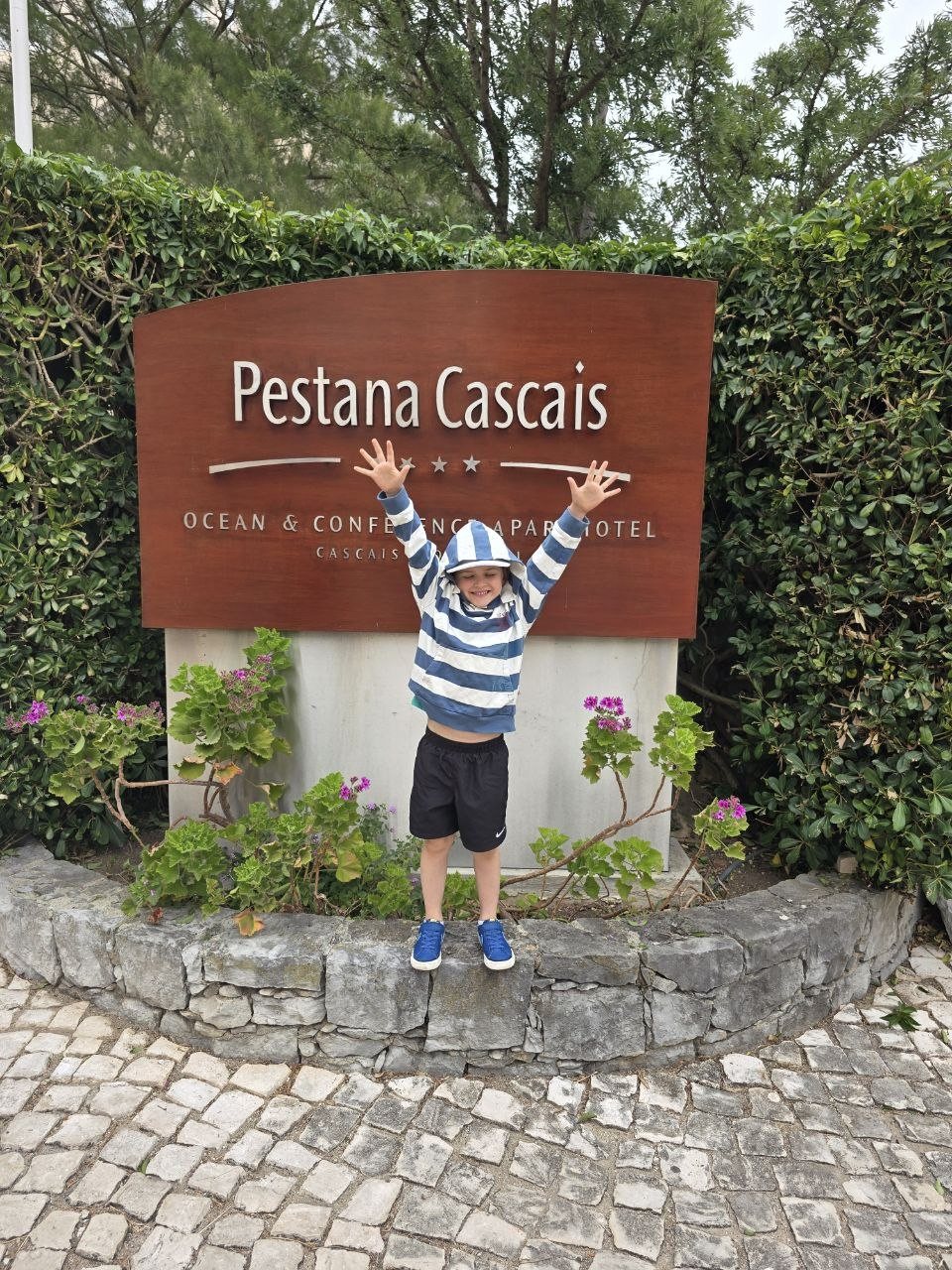 Noah posing at the Pestana Cascais sign