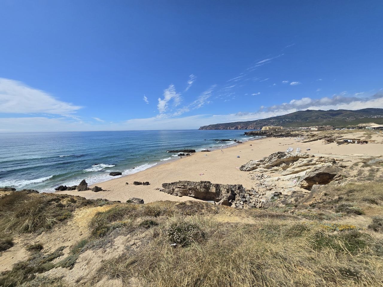 Wide coastal view of sandy beach and ocean near Cascais
