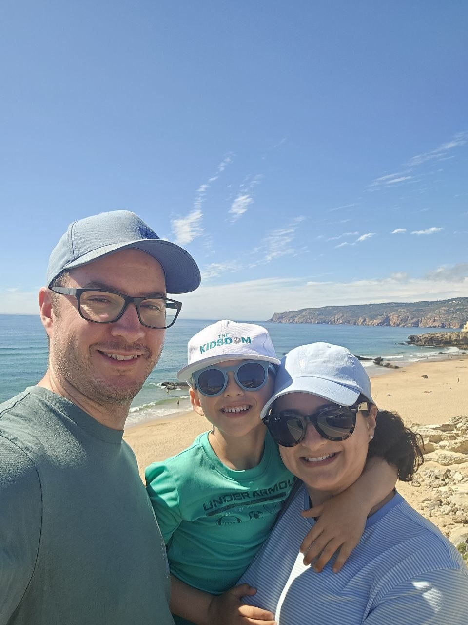 Family selfie above a sunny Cascais beach
