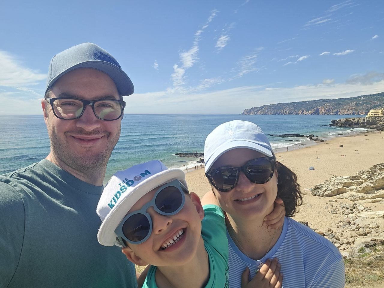 Close family selfie with ocean and beach behind