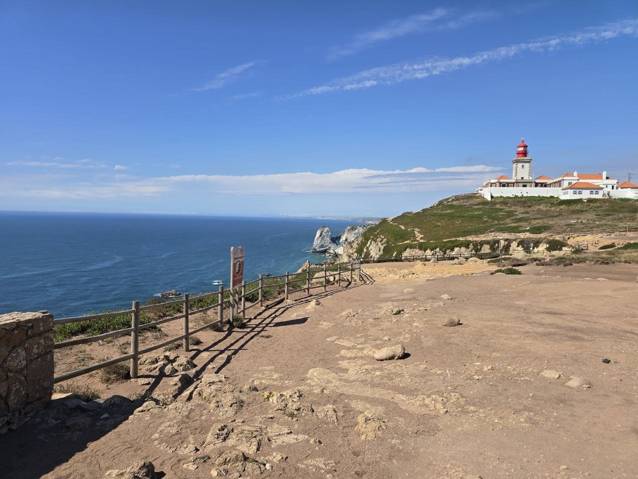Coastal viewpoint with lighthouse buildings on a headland
