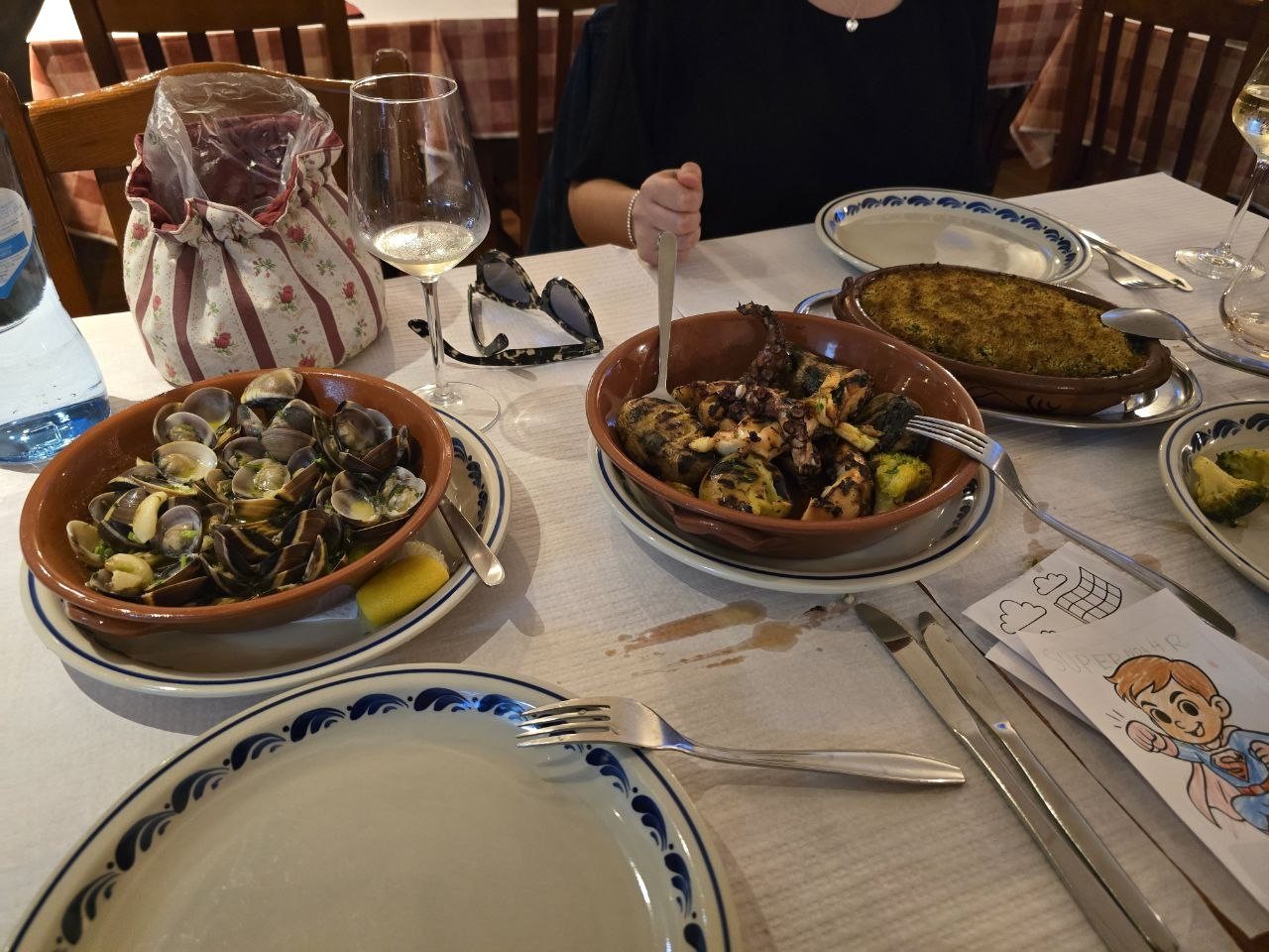 Clams, grilled octopus, baked cod, and plates at Restaurant Pereira