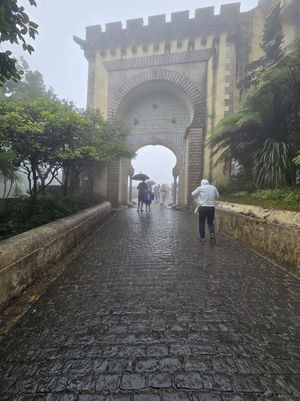 Rainy arched gate entrance at Pena Palace in Sintra