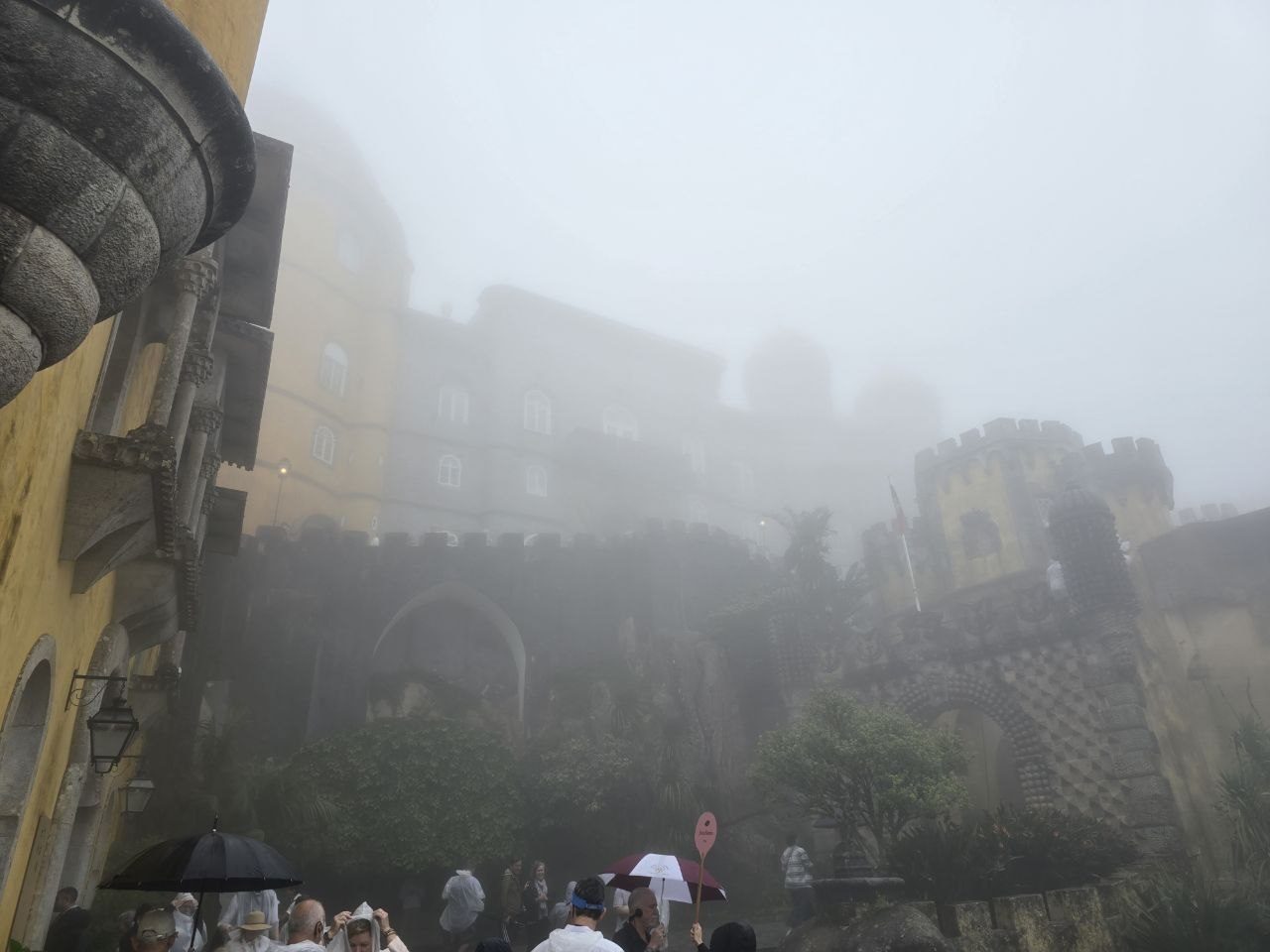 Pena Palace walls and towers partly hidden by heavy fog