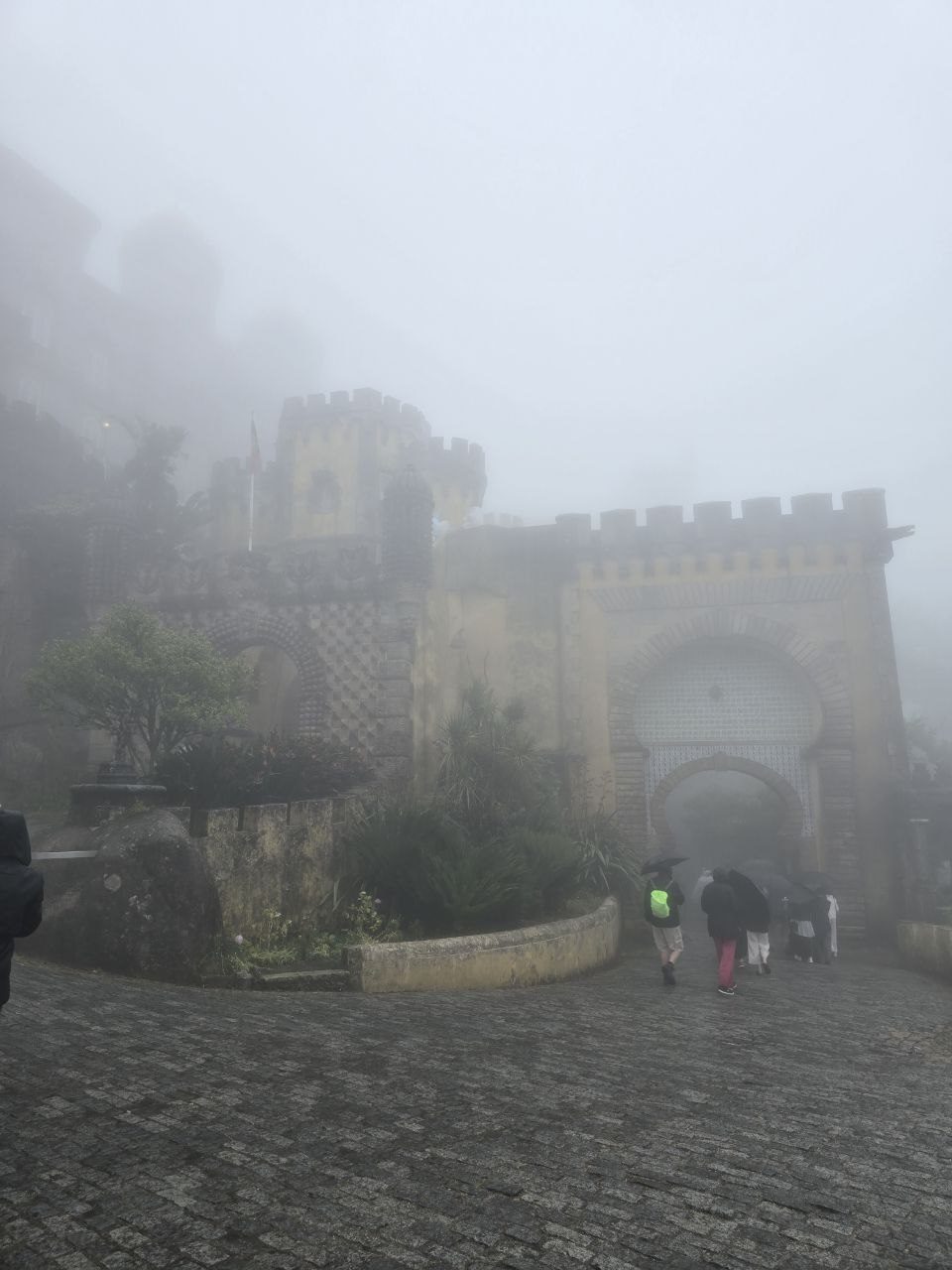 Foggy path and arched palace gate at Pena Palace