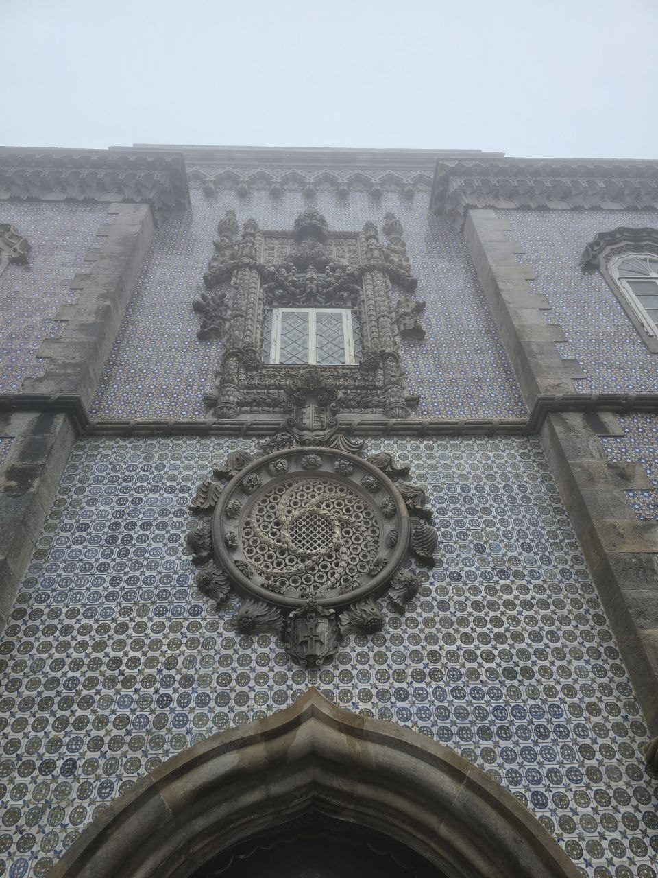 Decorative Pena Palace facade with patterned tiles and stone crest