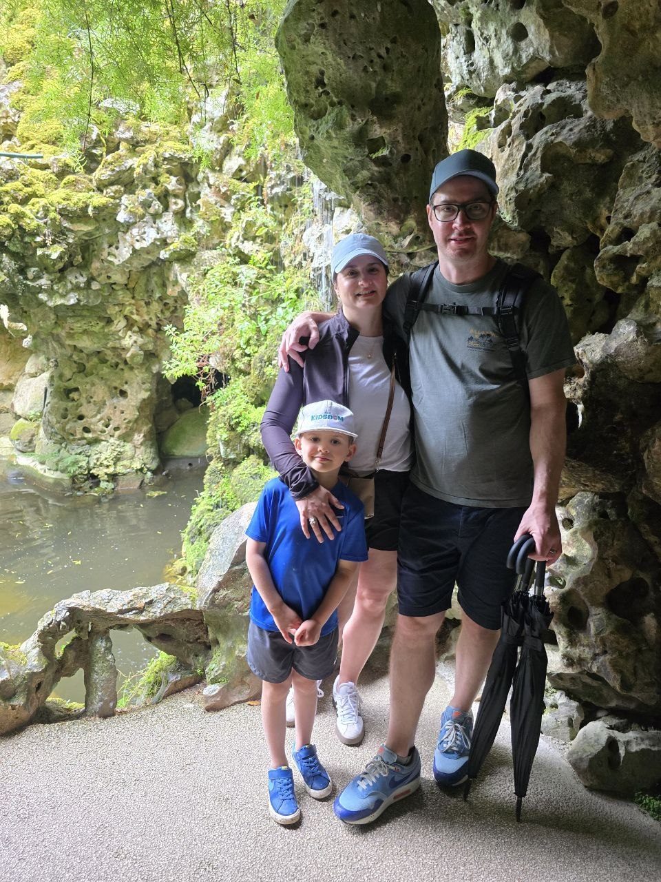 Family posing together inside a grotto at Quinta da Regaleira