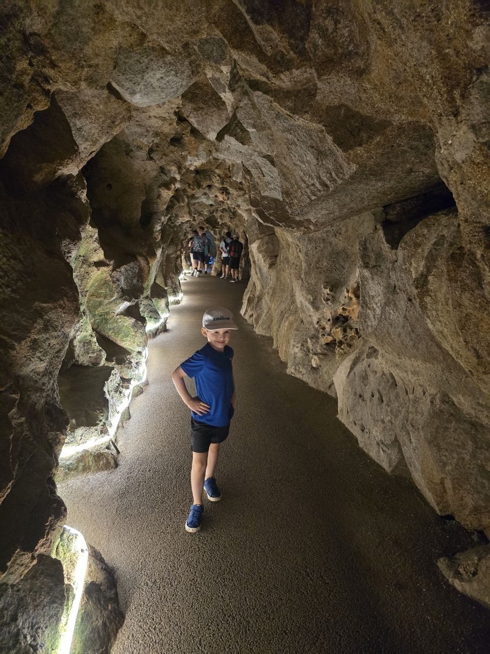 Noah walking through a rocky underground tunnel