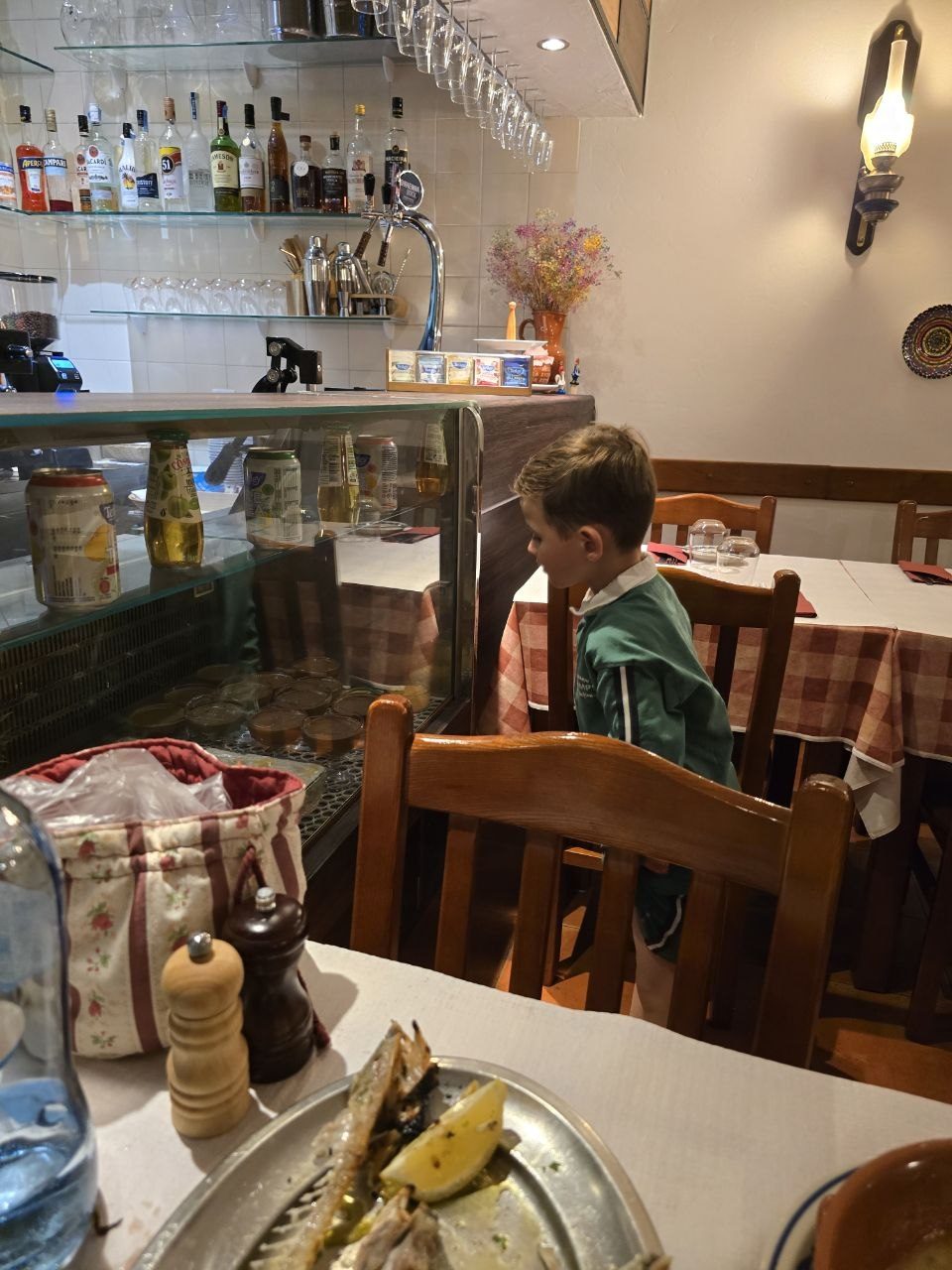 Noah looking into a restaurant dessert and drink fridge