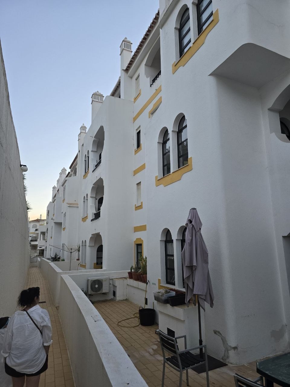 White-and-yellow Algarve condo buildings and walkway in Carvoeiro
