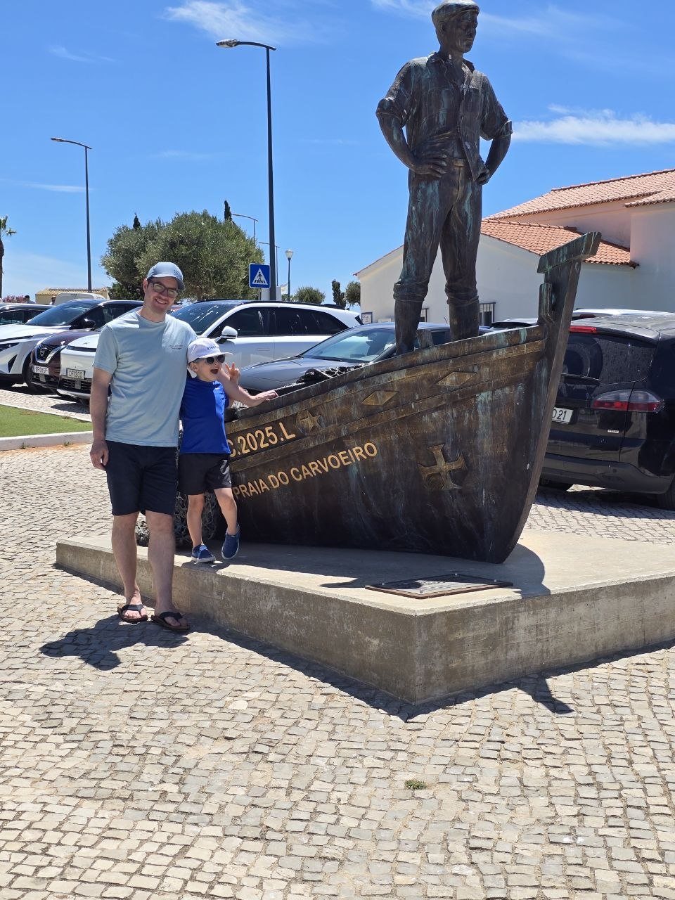 Noah standing beside a boat statue in Carvoeiro