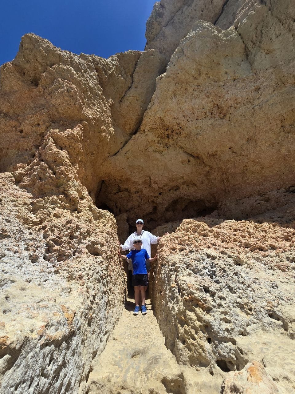 Noah walking between tall limestone rock walls