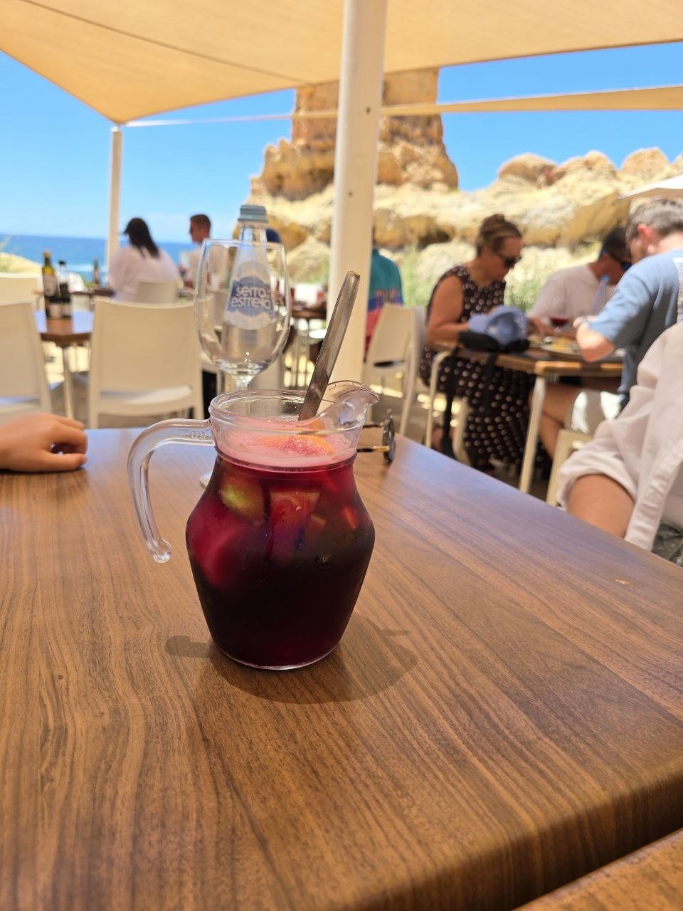 Small jug of red sangria on a wooden Boneca Bar table