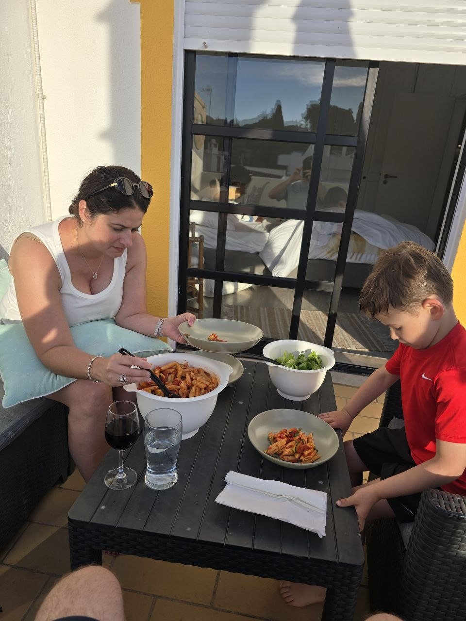 Catherine and Noah eating pasta dinner on the condo terrace