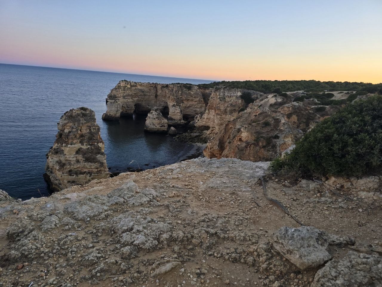 Marinha Beach rock stacks and cliff caves at sunset