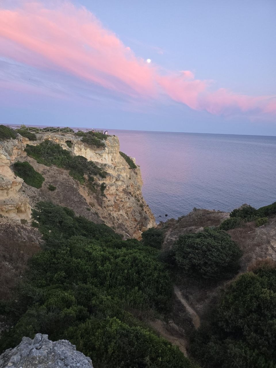 Pink clouds over a clifftop viewpoint and the Atlantic Ocean