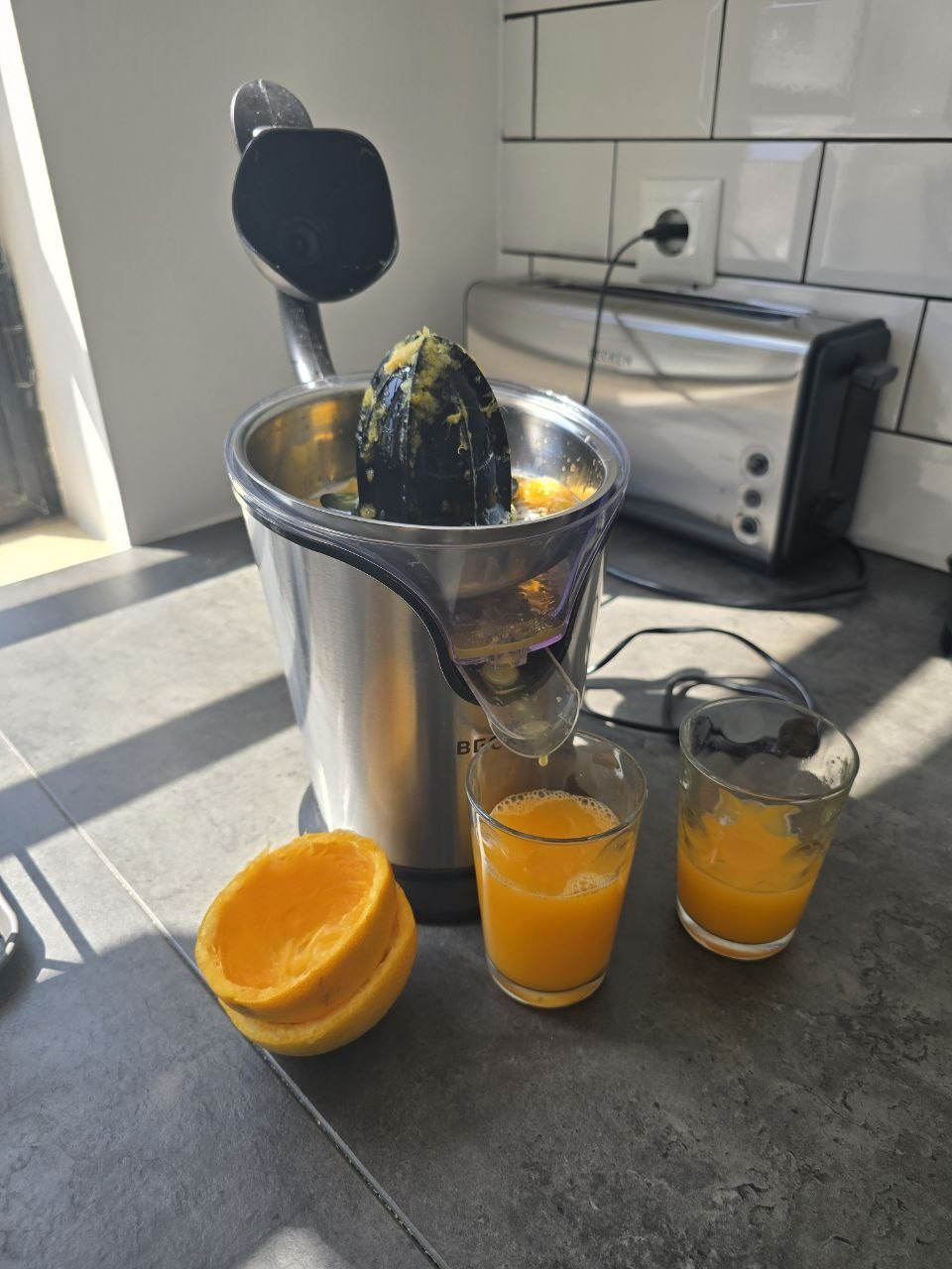 Fresh orange juice being squeezed on the condo counter