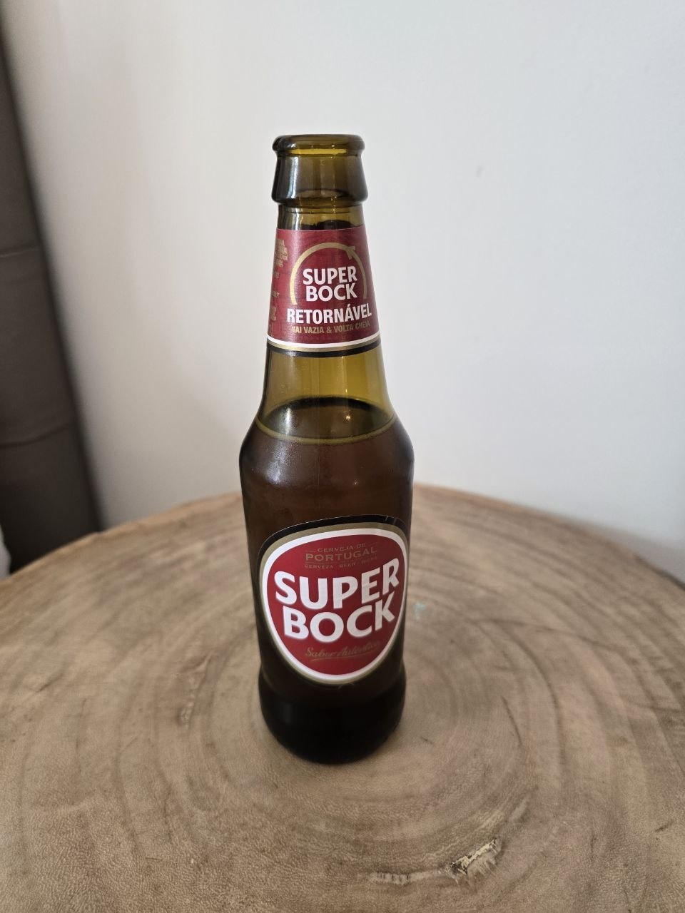 Bottle of Super Bock Portuguese beer on a wooden table