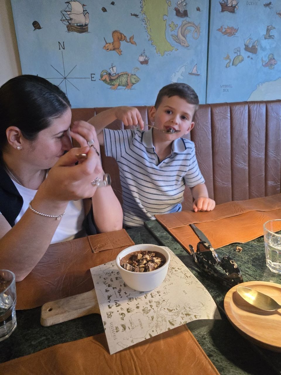 Family sharing a small dessert or ramekin at Restaurante Geographia