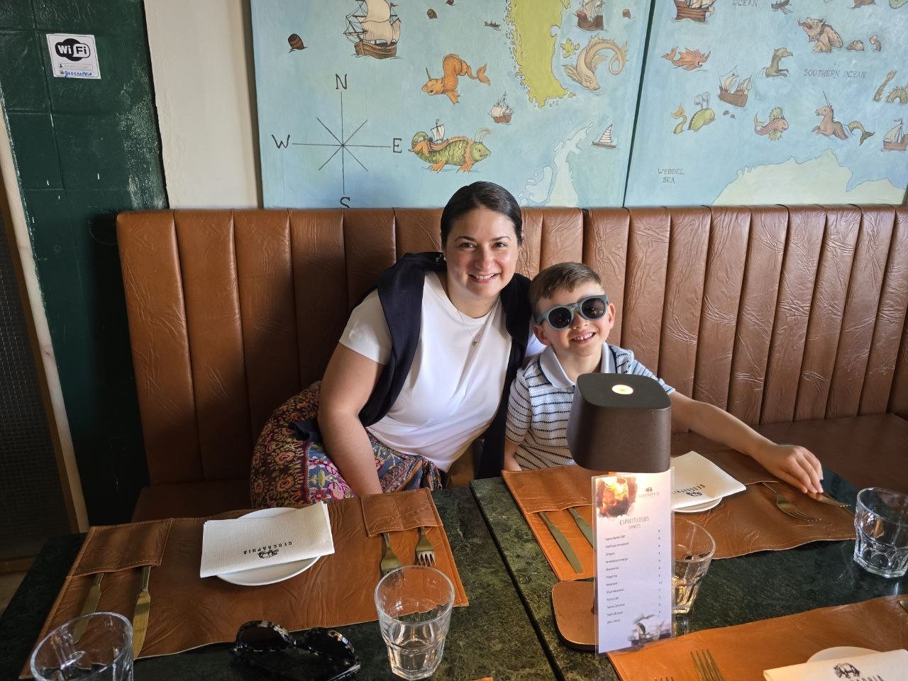 Catherine and Noah sitting at a table inside Restaurante Geographia in Lisbon
