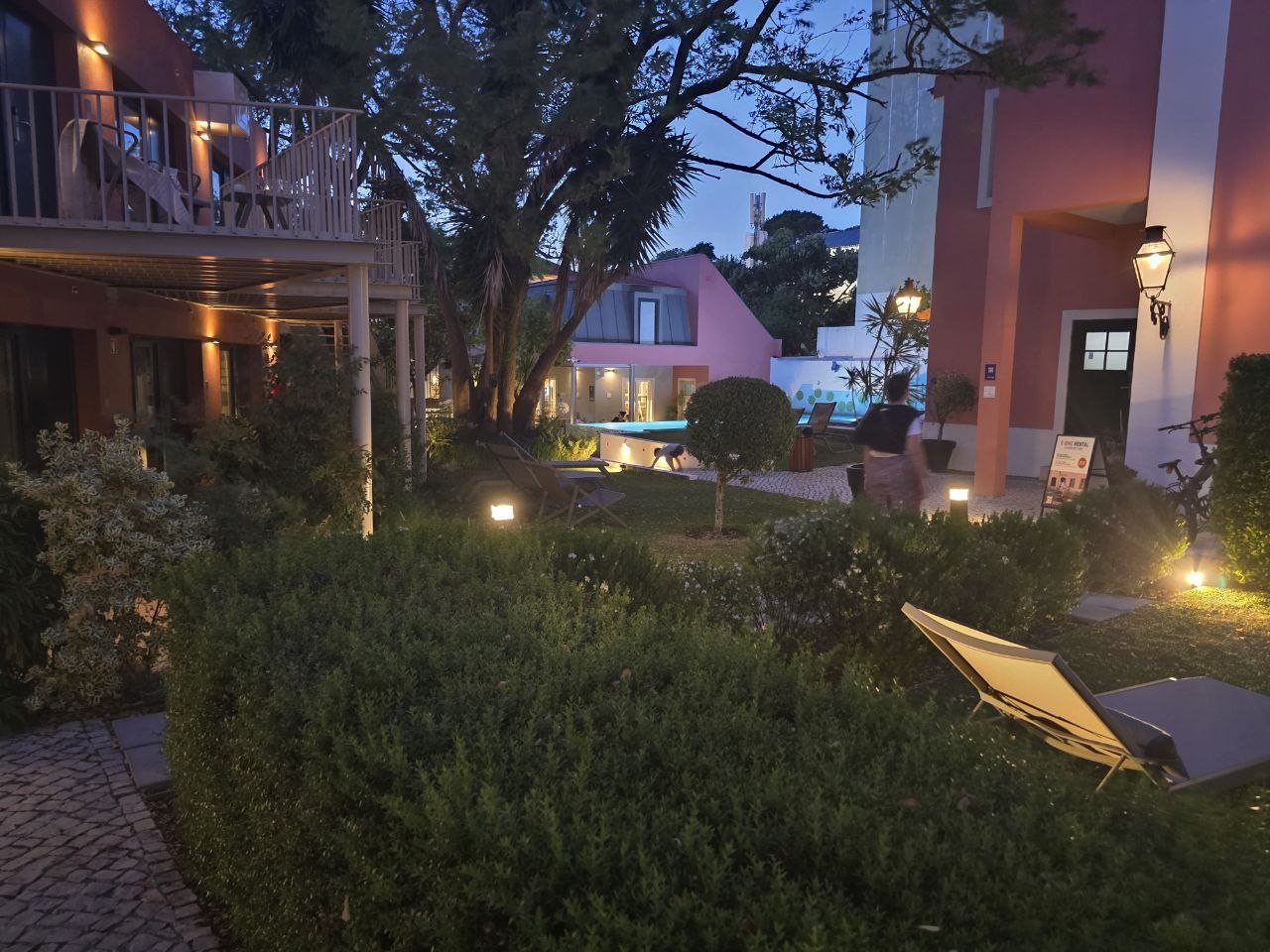 Jardim da Lapa garden and pool area lit up at dusk