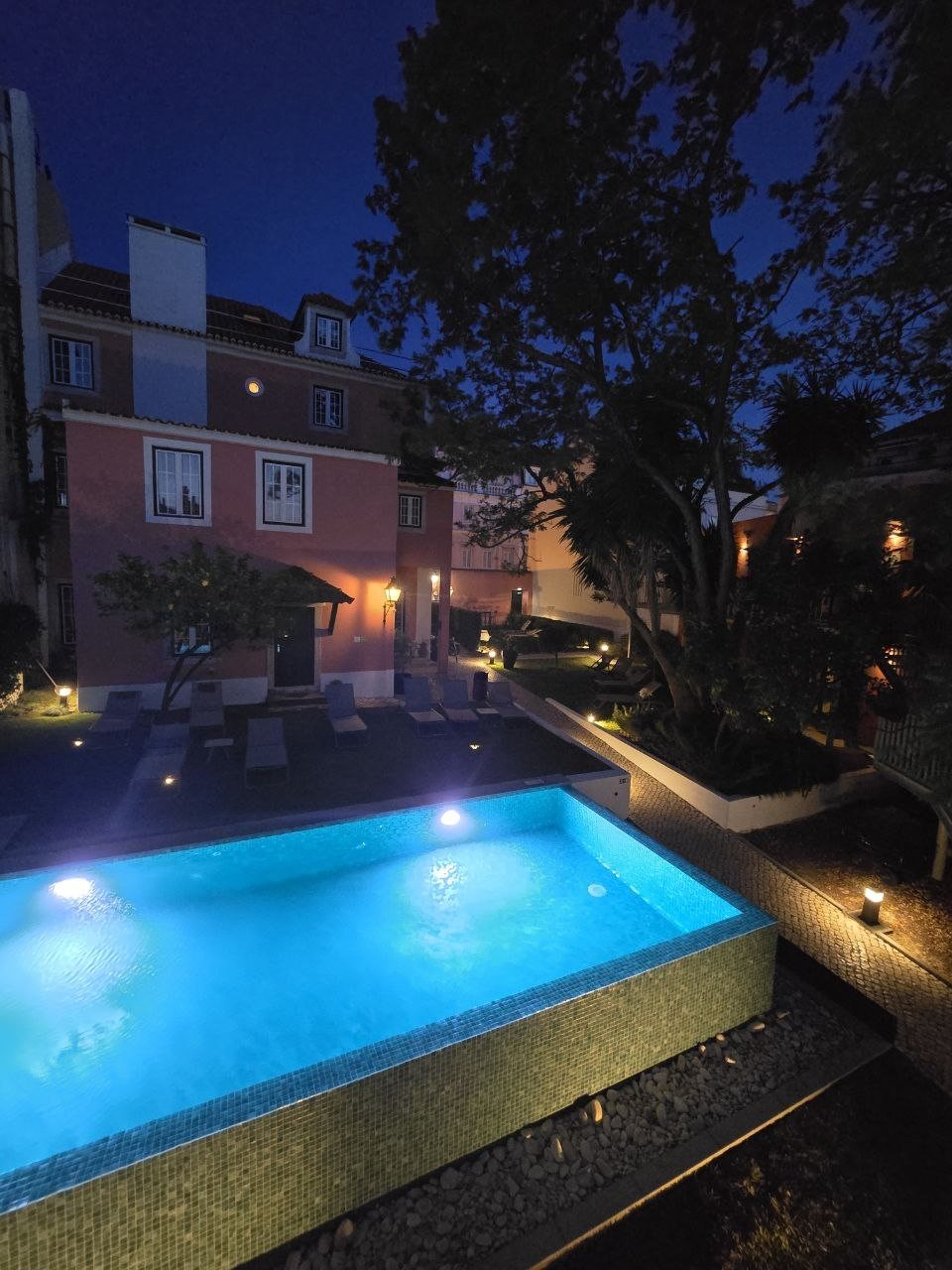 Jardim da Lapa pool glowing blue at night